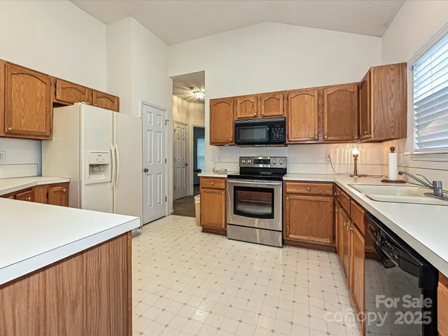 a kitchen with stainless steel appliances a stove sink microwave and cabinets