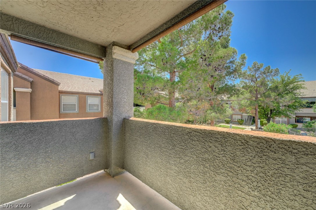 555 East Silverado Ranch Boulevard, Unit 2124 Las Vegas, NV 89183 - Photo 33 of 47 Enjoy tranquil vistas from this private balcony, offering serene tree and neighborhood views.