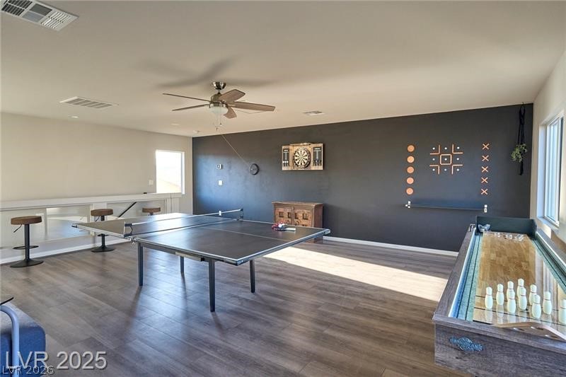 6302 Jackson Spring Road Las Vegas, NV 89118 - Photo 19 of 23 An inviting recreation area features plank flooring, a classic dartboard, and an arcade shuffleboard.
