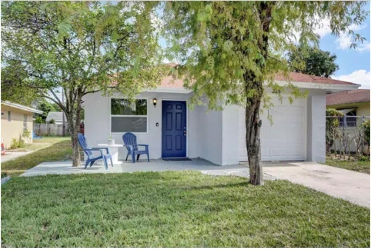 325 Southwest 4th Avenue Delray Beach, FL 33444 - Photo 2 of 16 a view of a house with backyard and a tree