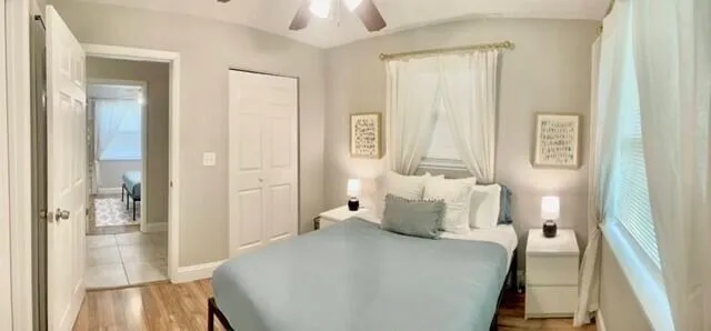 a bedroom with a bed and wooden floor