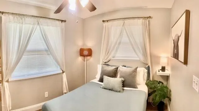 a bedroom with a bed and window