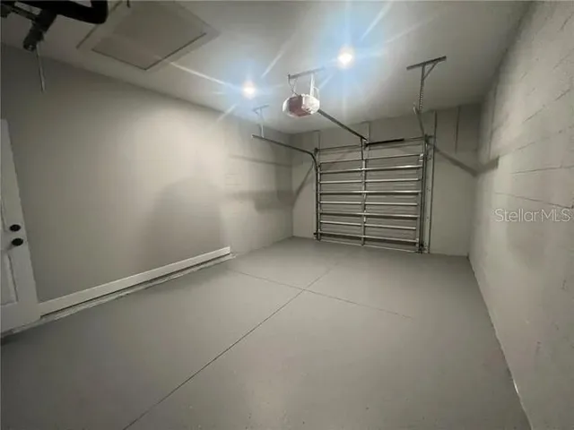 a view of empty room with stairs and white walls