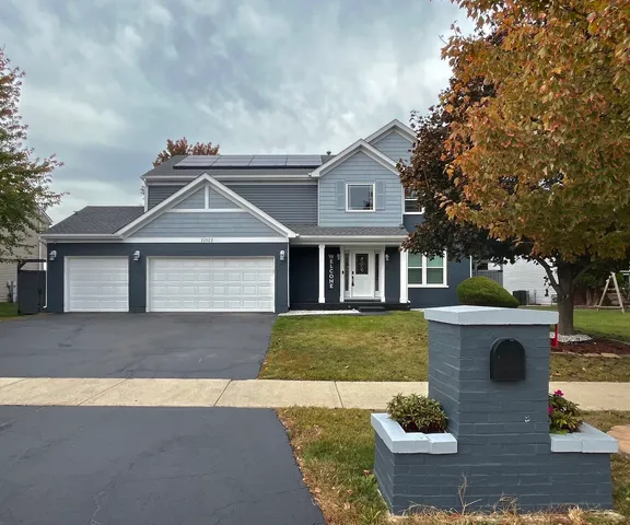a front view of a house with garden