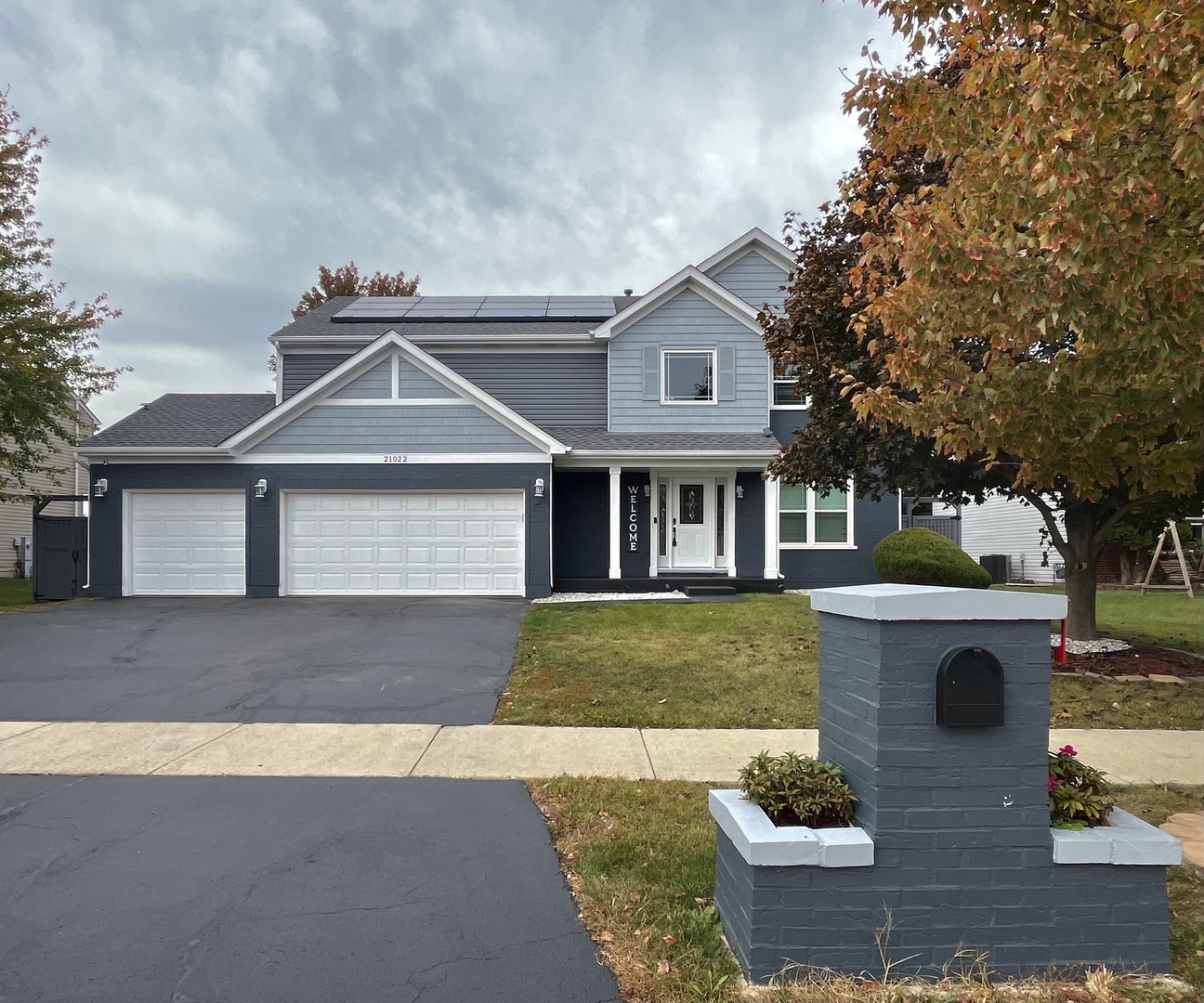 a front view of a house with garden