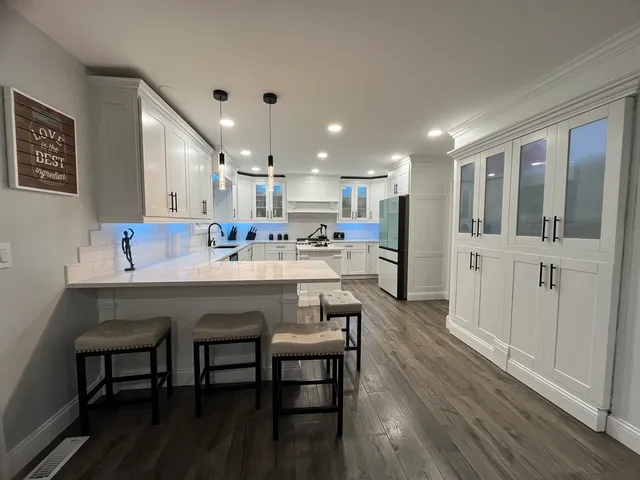 a kitchen with a sink cabinets and wooden floor
