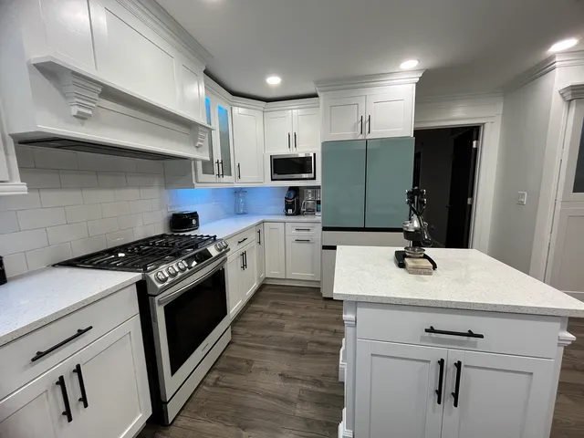 a kitchen with a sink stainless steel appliances and cabinets