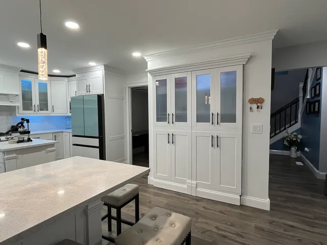 a kitchen with stainless steel appliances granite countertop a refrigerator and a stove top oven