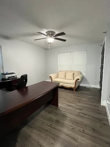 a living room with furniture and a ceiling fan