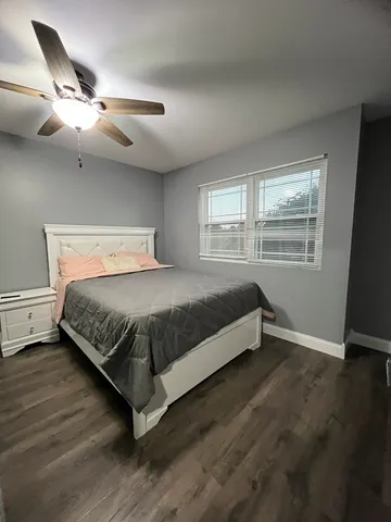 a bedroom with a bed and window