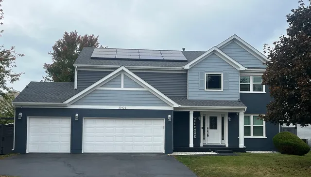 a front view of a house with a yard and garage