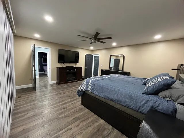 a bedroom with a large bed and a tv