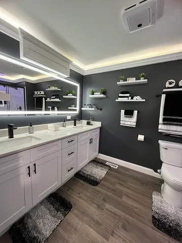 a spacious bathroom with a double vanity sink and a mirror