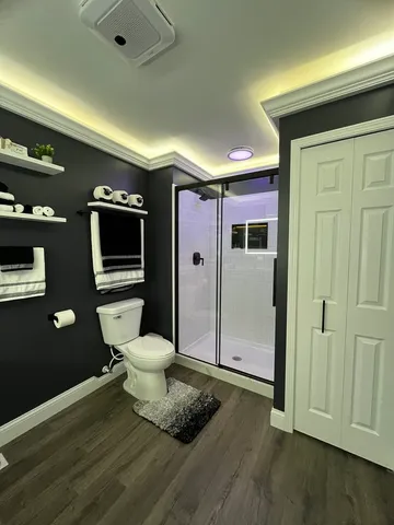 a bathroom with a toilet a sink and mirror