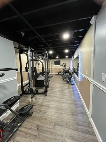 a open kitchen with stainless steel appliances granite countertop a stove and a wooden floors