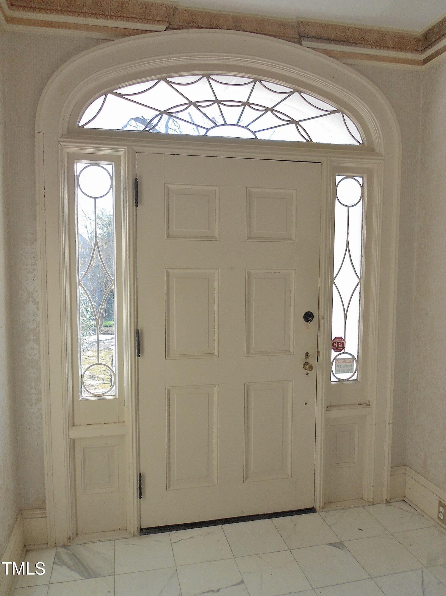 Classic over-width front door with sidelights and a gorgeous fanlight above