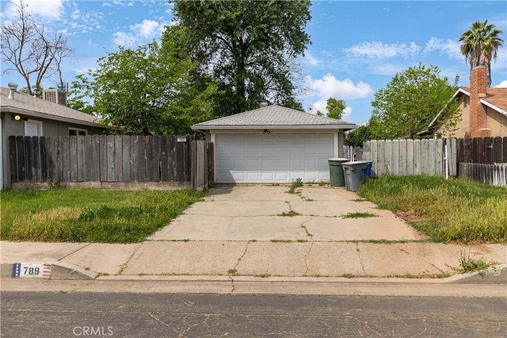 789 Yosemite Parkway Merced, CA 95340 - Photo 16 of 19 a view of a backyard with a garden and trees