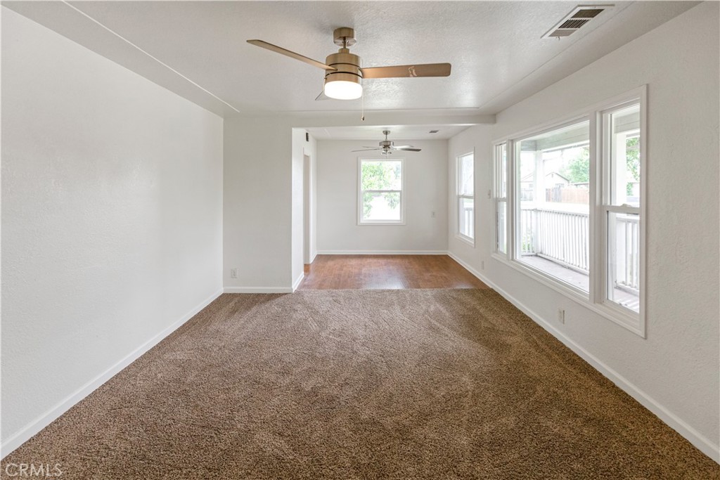 789 Yosemite Parkway Merced, CA 95340 - Photo 7 of 19 an empty room with windows and ceiling fan