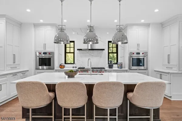 a large kitchen with a table and chairs