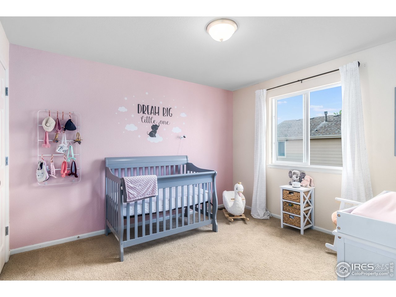 10435 Lower Ridge Road Longmont, CO 80504 - Photo 12 of 26 a bedroom with a baby bed a couch and a window