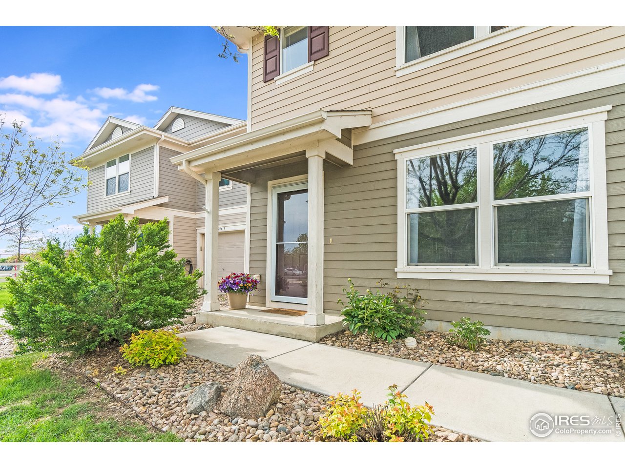 10435 Lower Ridge Road Longmont, CO 80504 - Photo 2 of 26 a front view of a house with a yard and potted plants