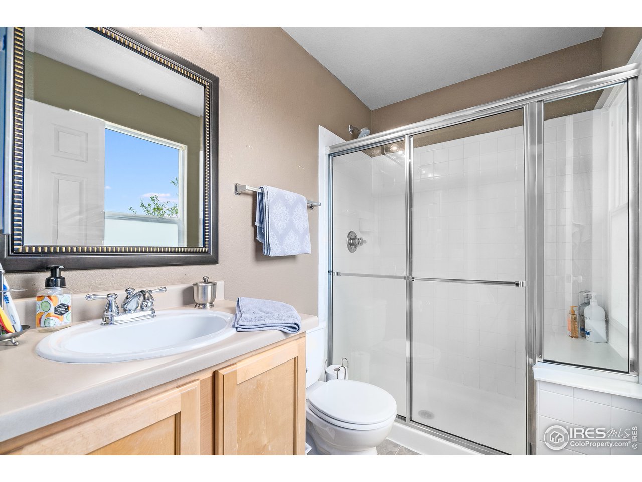 10435 Lower Ridge Road Longmont, CO 80504 - Photo 22 of 26 a bathroom with a sink toilet and shower