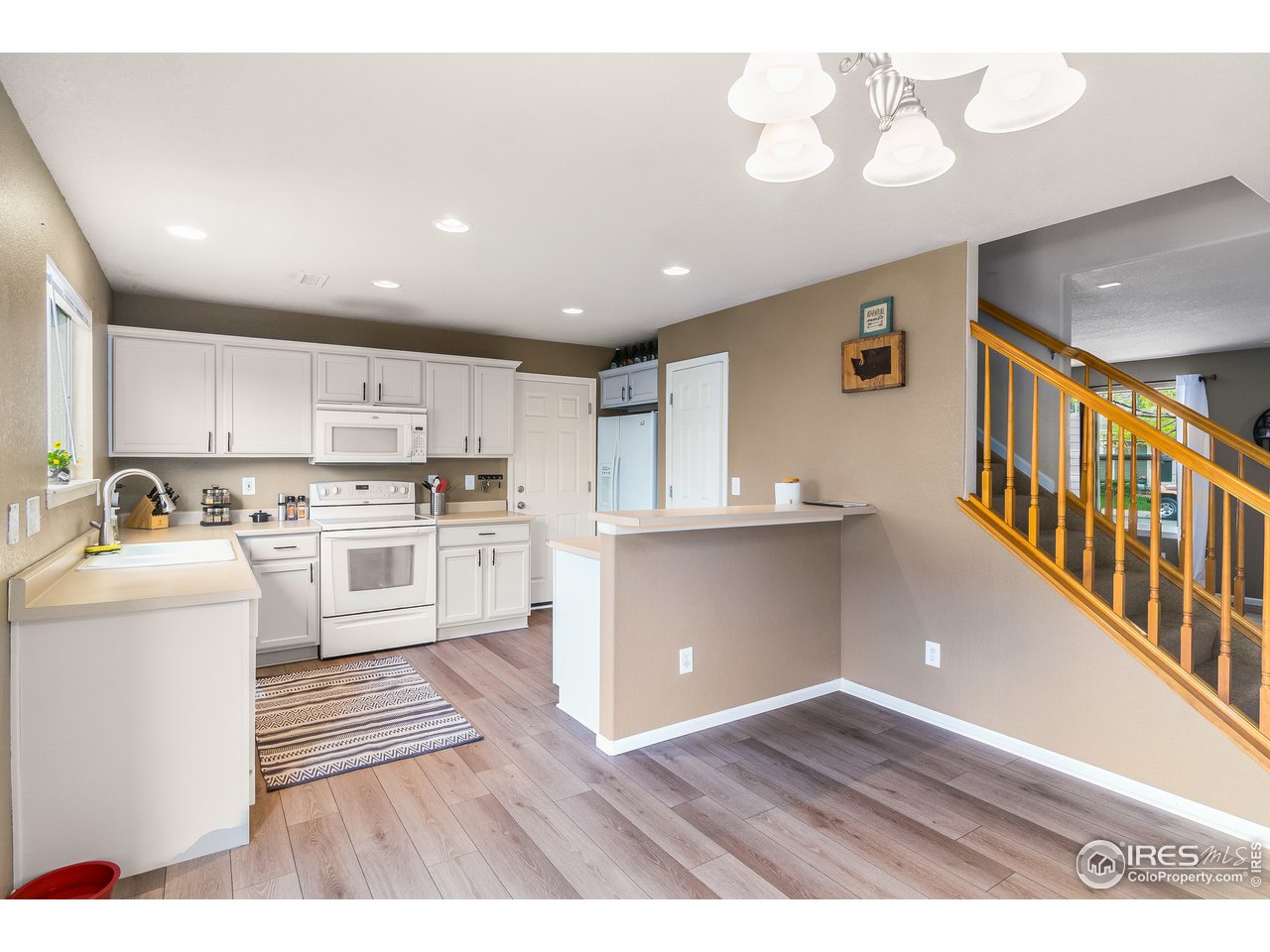 10435 Lower Ridge Road Longmont, CO 80504 - Photo 7 of 26 a view of kitchen with wooden floor