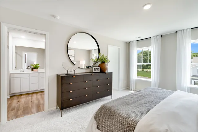 a bedroom with a bed and a dresser