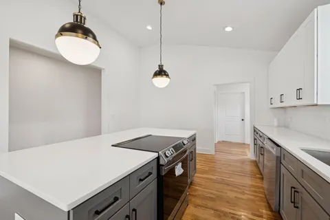 a dining room with furniture a chandelier and wooden floor