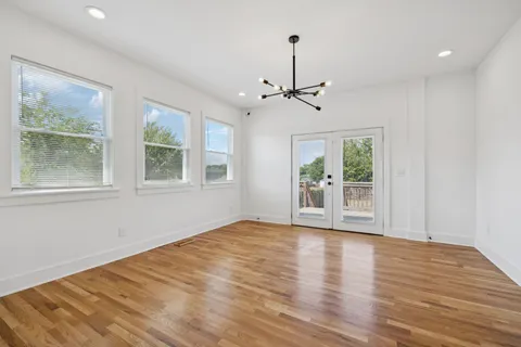 a view of room with window and hardwood floor