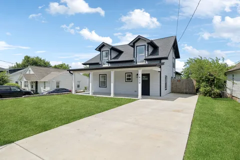a front view of a house with a garden and mountain view