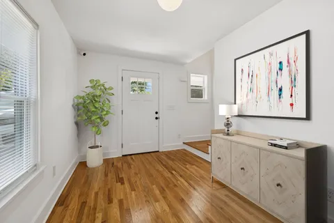 a kitchen with a sink cabinets and wooden floor