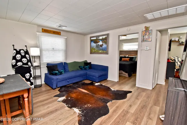 a living room with furniture and wooden floor