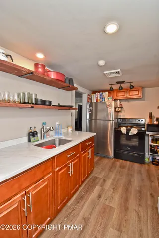 a kitchen with stainless steel appliances granite countertop a sink and cabinets