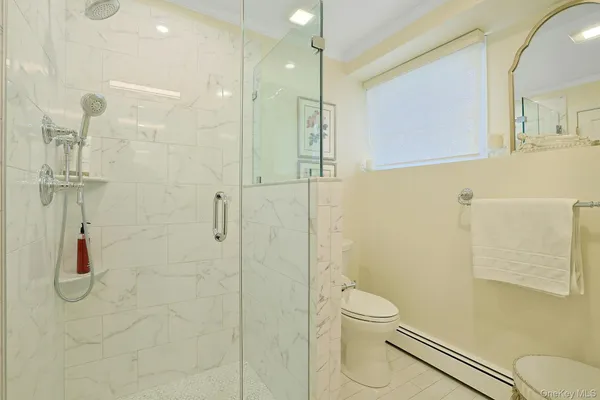 a bathroom with a shower a toilet and sink