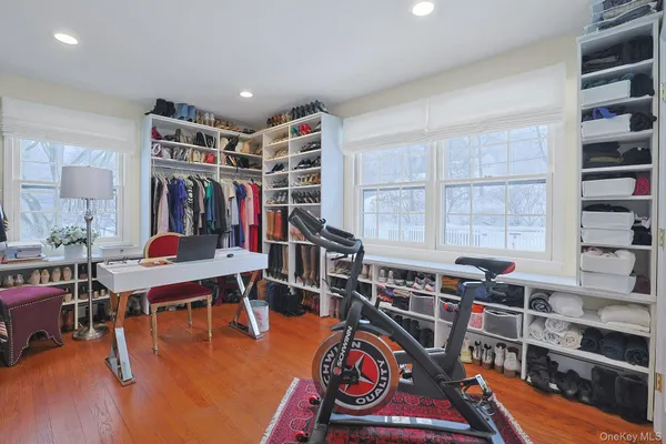 a living room with furniture a rug and a book shelf