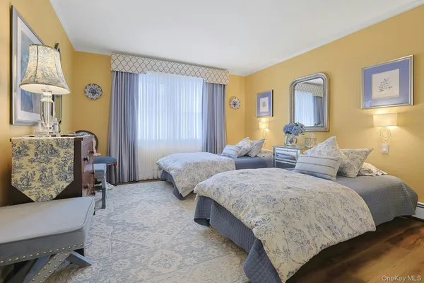a bedroom with two beds and painting on the wall