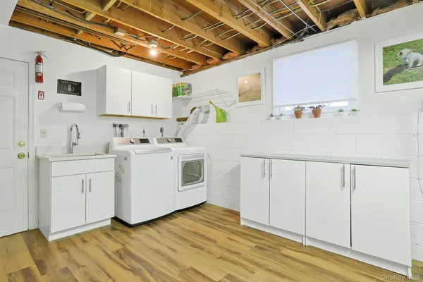 a utility room with cabinets washer and dryer