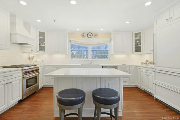a kitchen with a stove and white cabinets