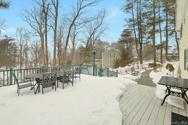 a view of a patio with table and chairs with wooden floor and fence
