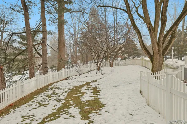 a view of a yard covered with snow in the back