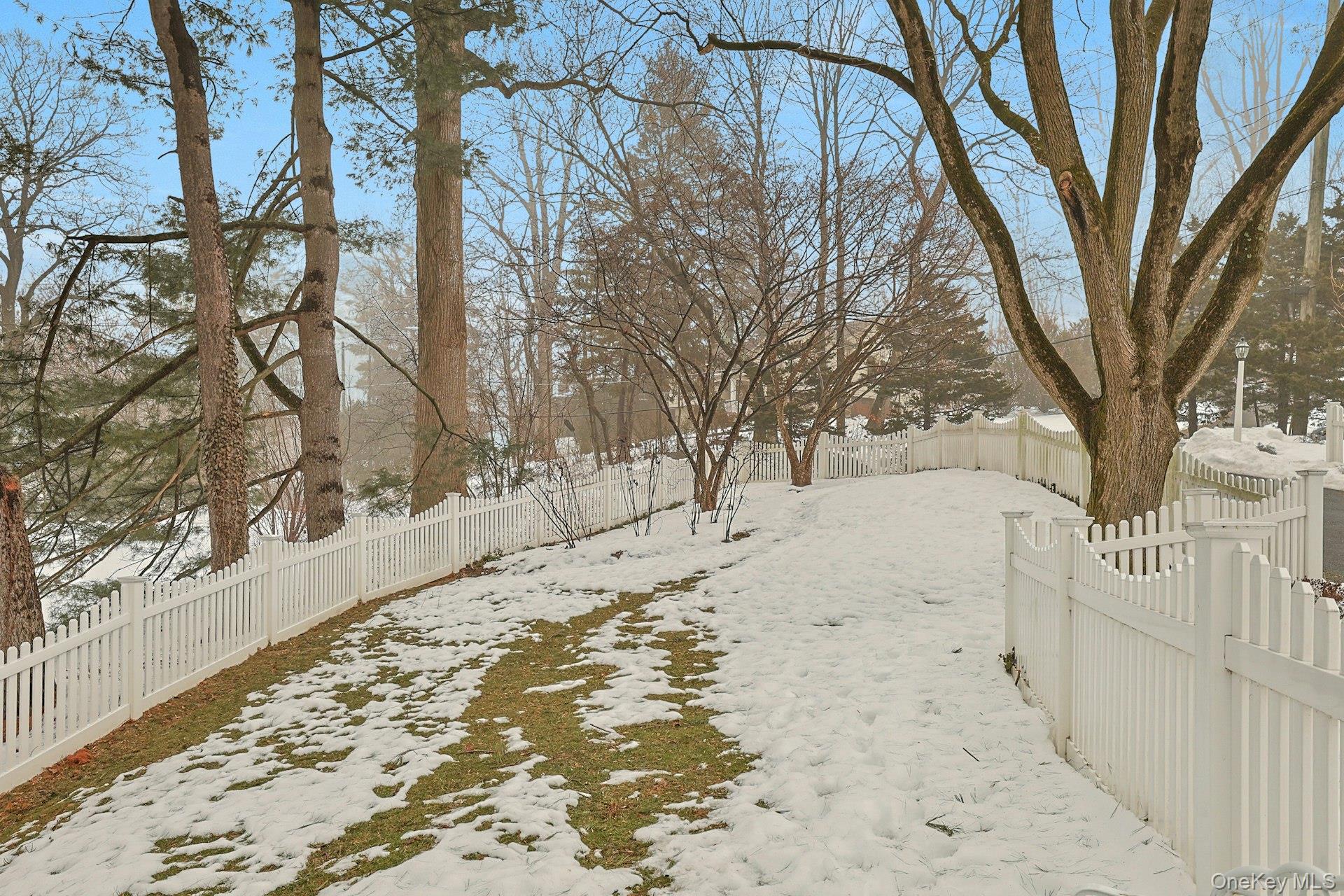 103 River Road Briarcliff Manor, NY 10510 - Photo 24 of 37 a view of a yard covered with snow in the back