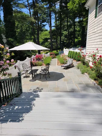 a view of a patio with a table and chairs under an umbrella