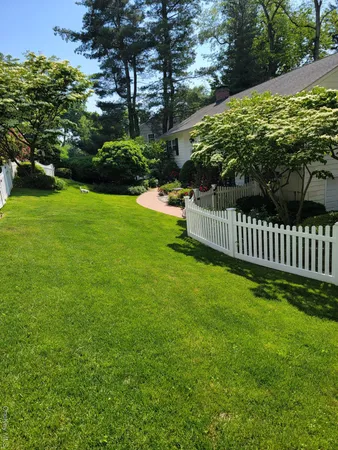 a view of garden with wooden fence
