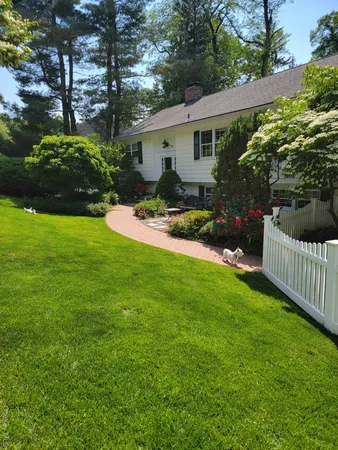 a view of a house with backyard and garden
