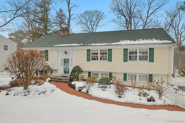 a view of a house with snow on the road