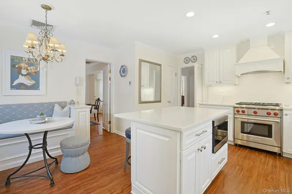 a kitchen with a stove and a chandelier