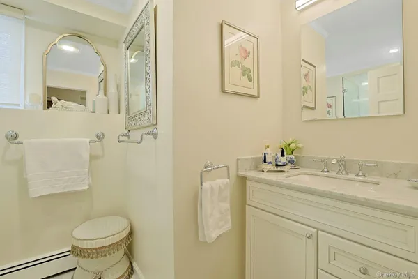 a bathroom with a granite countertop toilet sink and mirror