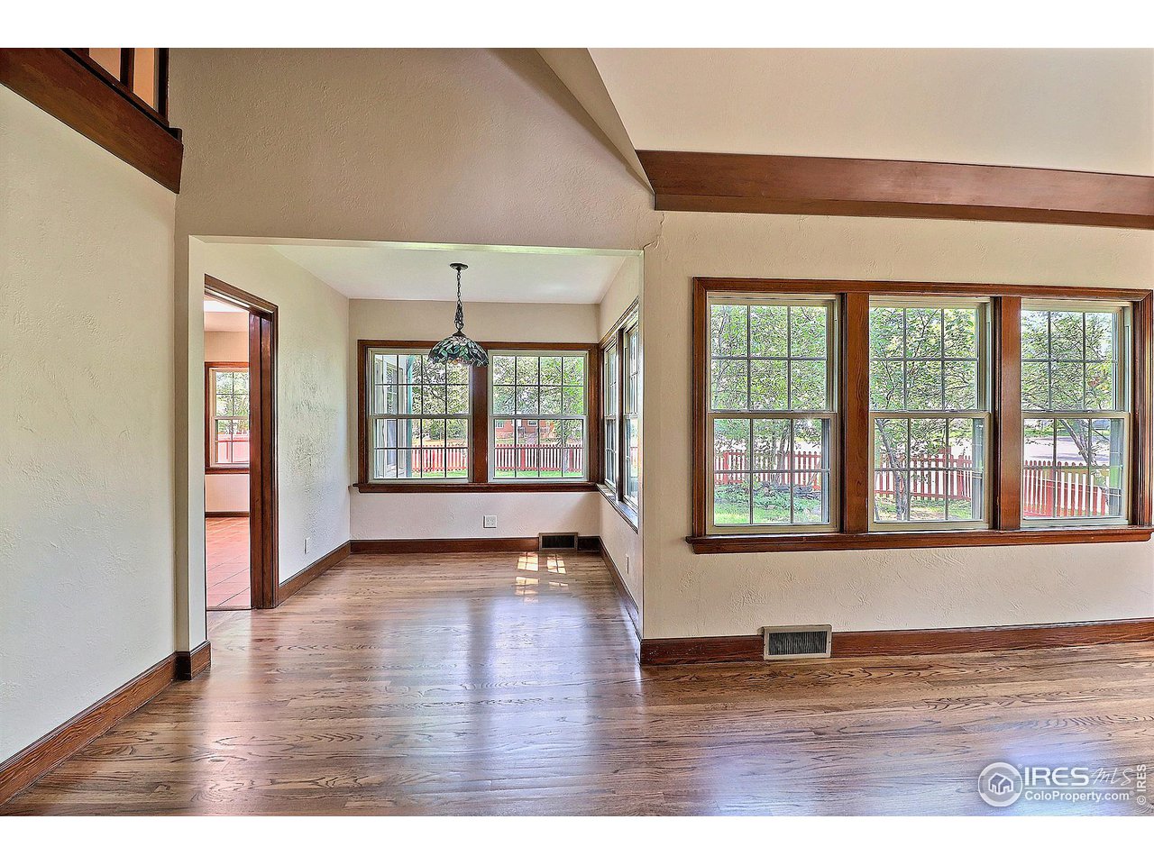 1607 Fairacre Drive Greeley, CO 80631 - Photo 11 of 40 an empty room with wooden floor and windows