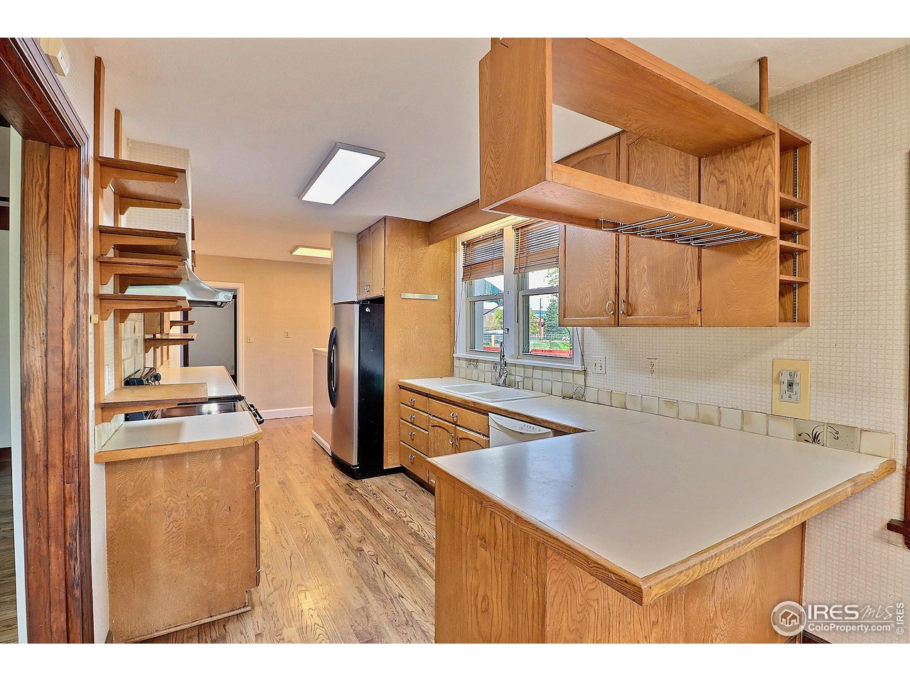 1607 Fairacre Drive Greeley, CO 80631 - Photo 13 of 40 a kitchen with stainless steel appliances kitchen island a refrigerator sink and cabinets